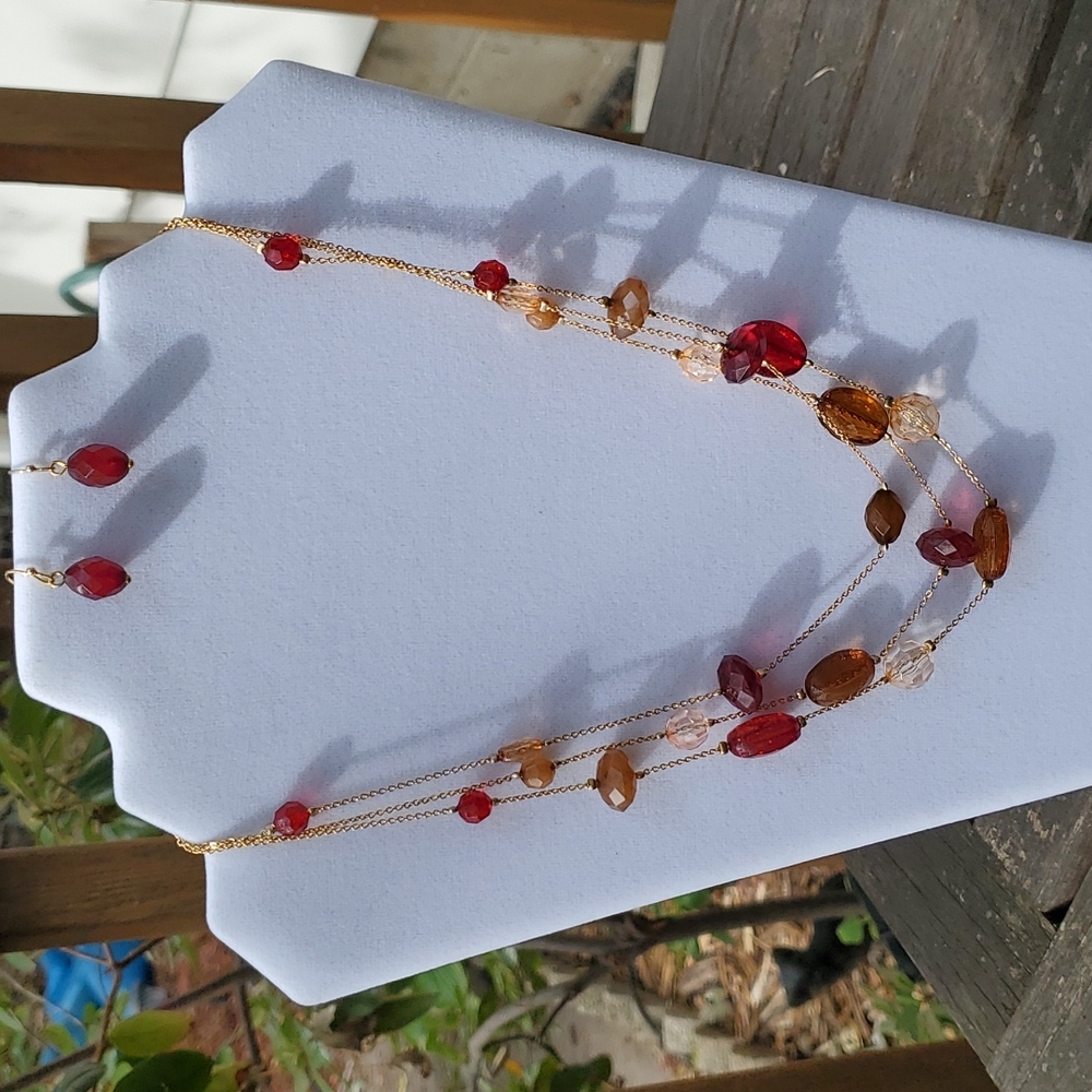 Vintage Avon triple strand beaded necklace and earring set. Still in box